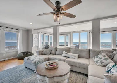 Stunning water view from living room windows. sectional sofa, ceiling fan ocean theme in Madison, CT